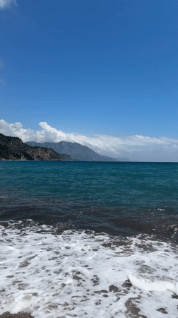 Peaceful coastal moment captured as jet crosses sunny Montenegro sky