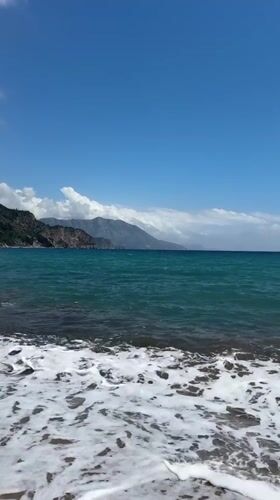 Peaceful coastal moment captured as jet crosses sunny Montenegro sky