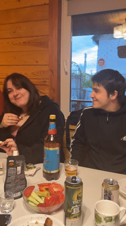 Friends gather for casual dinner party at Russian cabin