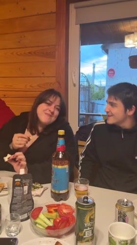 Friends gather for casual dinner party at Russian cabin