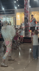 Children's costumed performance draws crowds at shopping mall stage