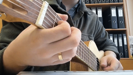 Morning street musician plays ukulele in Moscow