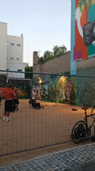 Makeshift volleyball game in a fenced outdoor space, Rüsselsheim
