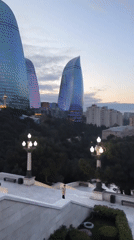Dusk panorama captures illuminated Baku skyline and Flame Towers