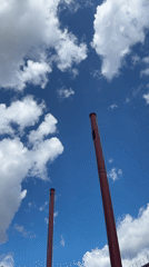 Exploring a decaying industrial site under dramatic skies