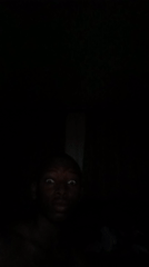 Person photographed in darkness with illuminated face in Lagos
