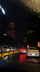 Rainy night drive captured through car windows in Yiwu