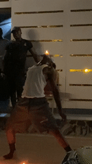Man performs fire dance during outdoor gathering in Kaduna