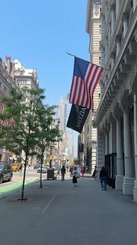 NYC street scene captures Empire State Building view with flags