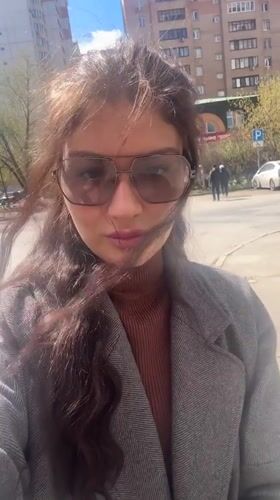 Person in aviator sunglasses observed on Krasnogorsk sidewalk