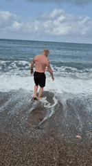 Man enjoys early morning swim at Alanya beach