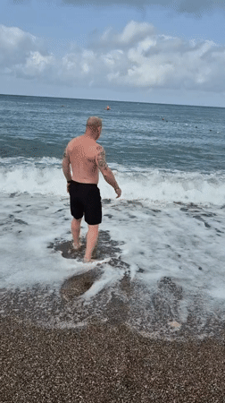 Man enjoys early morning swim at Alanya beach