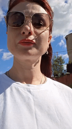 Woman films herself outdoors in sunny Смалявічы, Belarus