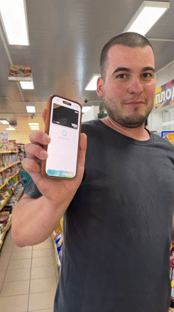 Customer makes contactless smartphone payment at Bulgarian store