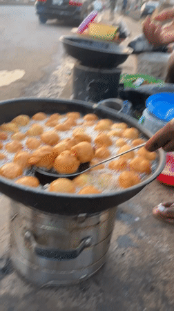 Street vendor fries dough balls in Bukuru, Nigeria