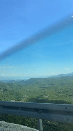 Vehicle passenger films scenic Montenegro mountain vista