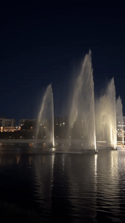 Nighttime fountain and fireworks display illuminates Cheboksary waterfront