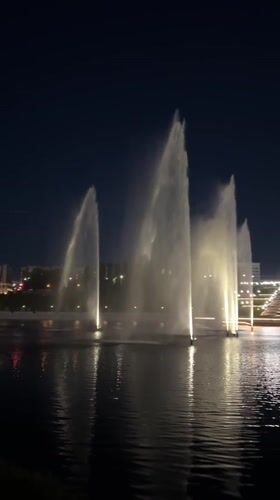 Nighttime fountain and fireworks display illuminates Cheboksary waterfront