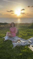 Woman enjoys seaside picnic with strawberries in Netanya
