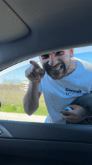 Man in branded shirt approaches car window in Plovdiv