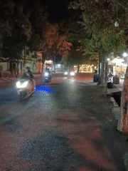 Purworejo street scene at night: vendors, bikes, and roadside stalls