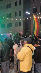 Nighttime concert crowd gathers under Bolivian flag in La Paz