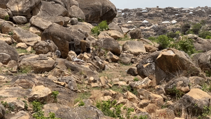 People gather on rocky hillside near Jos, Nigeria