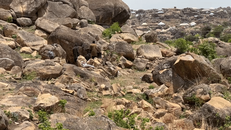 People gather on rocky hillside near Jos, Nigeria