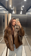 Woman takes elevator selfie in Belgrade amid casual social documentation