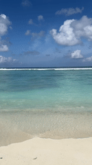 Beach day in the Maldives with seaplanes overhead