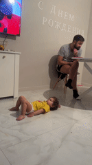 Toddler in yellow shirt observed on floor in Moscow home