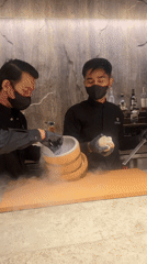 Black-themed dessert prep with liquid nitrogen and theatrical plating