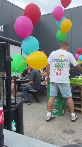 Casual summer gathering outside a modern building in Den Hoorn