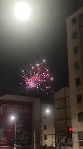 Fireworks light up a Milan street on a June night