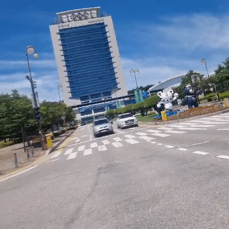 Driving through Gangneung past an Olympic landmark on a clear day