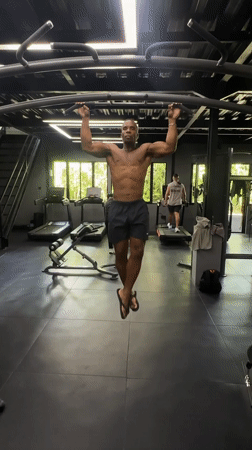 Man performs pull-ups at early morning gym session in Mengwi