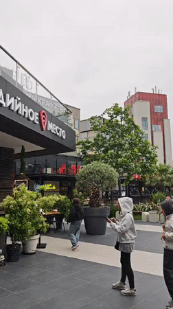 Ordinary afternoon activity captured at Sochi restaurant exterior