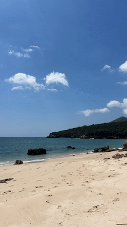 Man rests on tranquil beach in Setúbal, Portugal