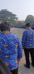 Government assembly in Metro, Indonesia — blue batik uniforms, formal formation