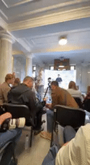 Speaker addresses audience at indoor event in Kyiv