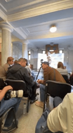 Speaker addresses audience at indoor event in Kyiv