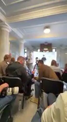 Speaker addresses audience at indoor event in Kyiv