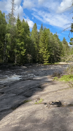 Drone operator documents equipment and river scenery in Bø