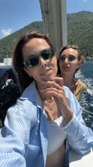 Young women film selfies on Montenegro ferry crossing