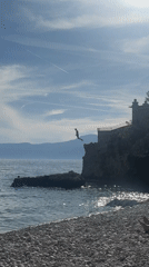 Cliff jumper leaps into sea near Rijeka, Croatia