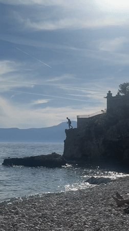 Cliff jumper leaps into sea near Rijeka, Croatia