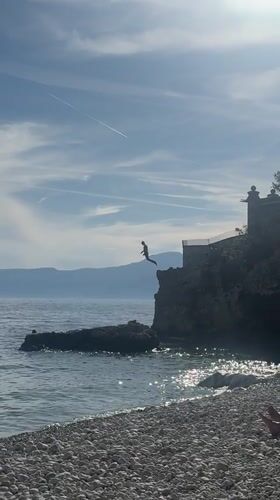 Cliff jumper leaps into sea near Rijeka, Croatia
