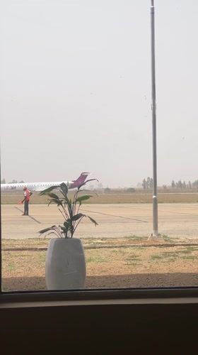 Airport tarmac activity observed from terminal in Nigeria
