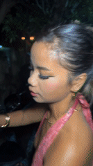 Woman observed on nighttime street in Denpasar, Indonesia