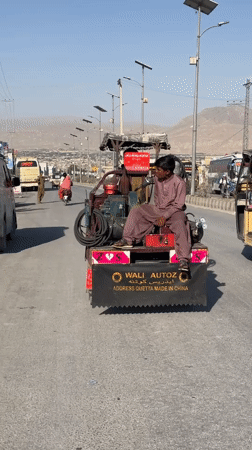Street life in Quetta with traditional dress and custom vehicles
